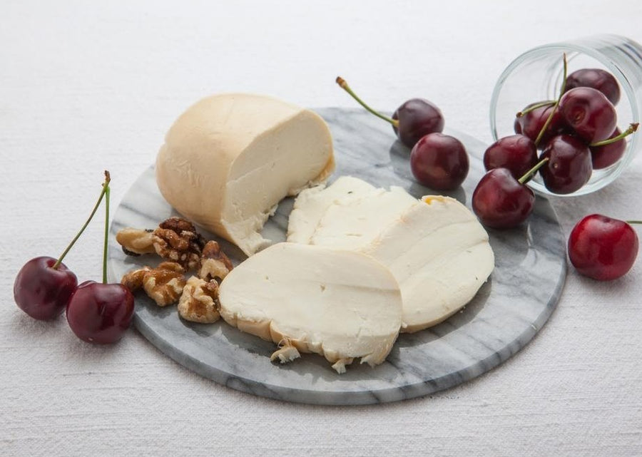 Maplebrook Farms Smoked Mozzarella Cheese sliced with cherries and walnuts
