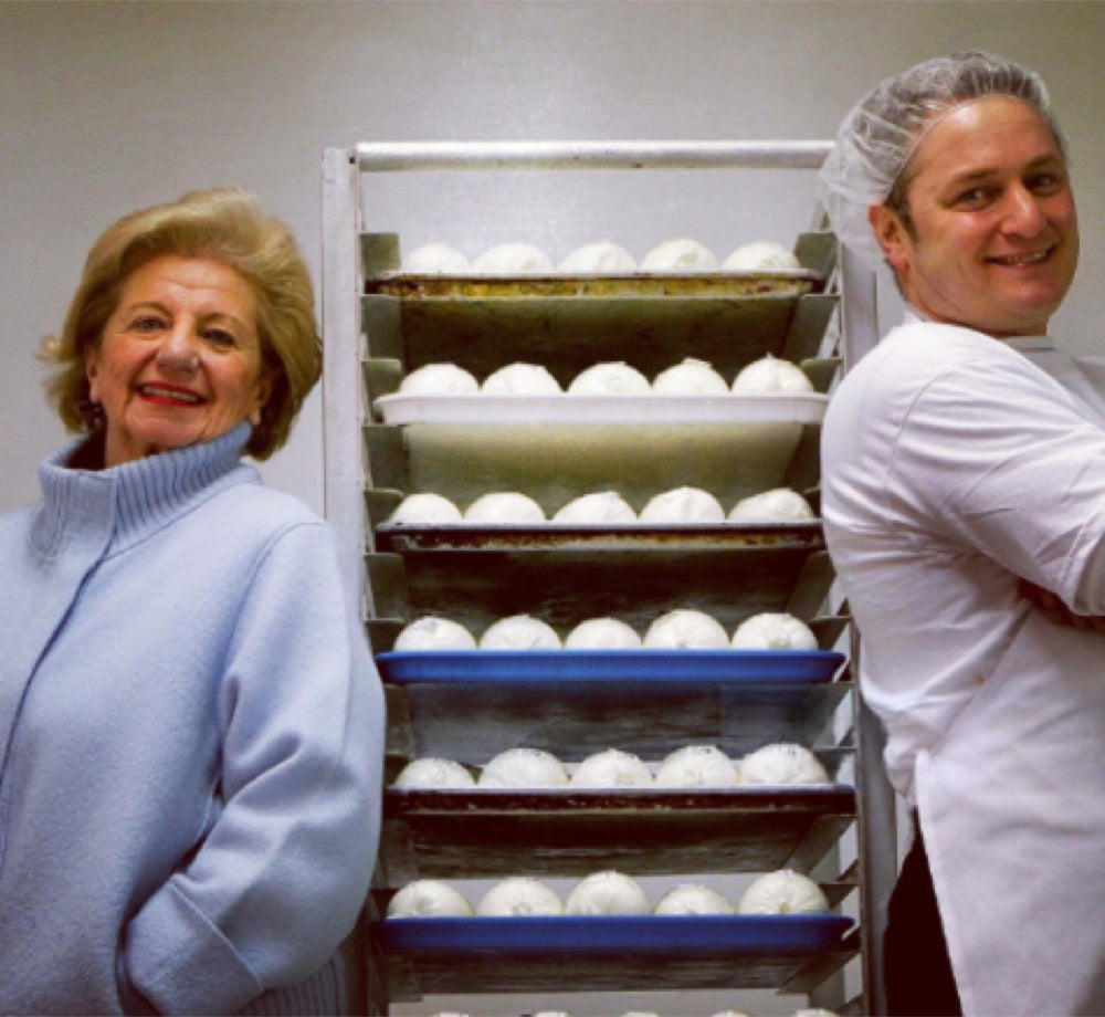 Johann Englert and Mike Scheps beside racks of fresh mozzarella